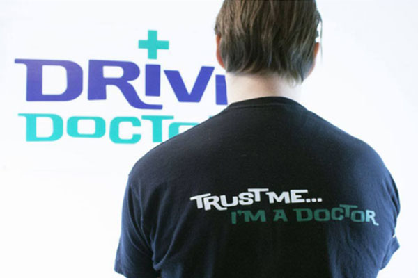 Back of a Drive Doctors T-shirt reading "Trust me... I'm a doctor" in front of the Drive Doctors logo