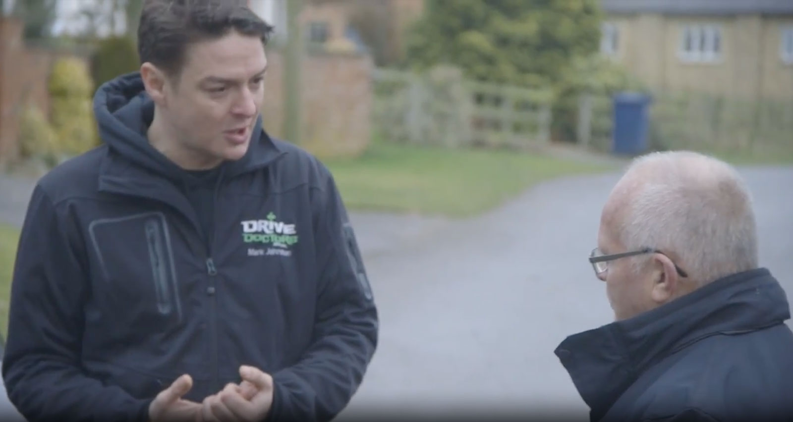 Mark Johnston, co-founder of Drive Doctors, talking with a man on a country road